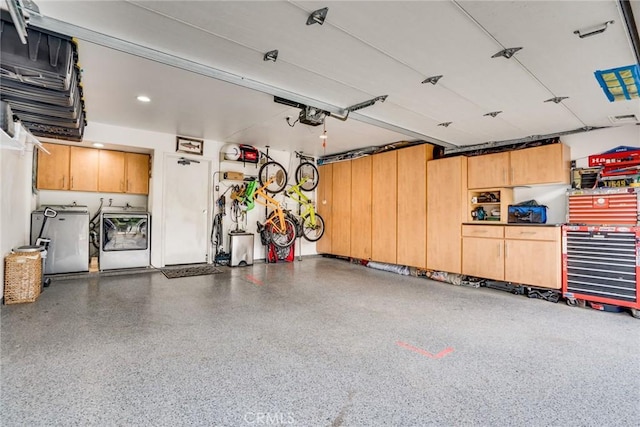 garage with a garage door opener and washing machine and dryer