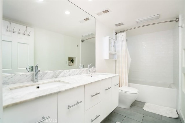 bathroom with toilet, visible vents, and a sink