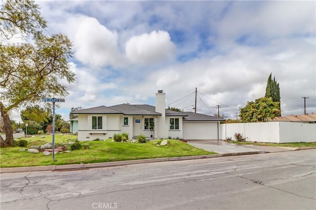 ranch-style home with a front yard, fence, a chimney, concrete driveway, and crawl space