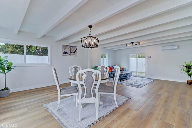 dining space with beam ceiling, a wall mounted AC, light wood-style floors, baseboards, and a chandelier