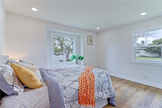 bedroom with recessed lighting, baseboards, and wood finished floors