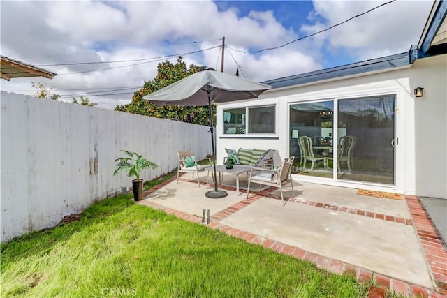 view of patio / terrace featuring fence