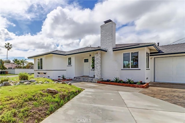 prairie-style home featuring decorative driveway, crawl space, an attached garage, and stucco siding