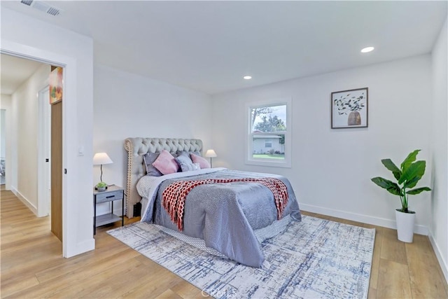 bedroom with recessed lighting, visible vents, baseboards, and light wood finished floors