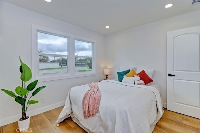 bedroom featuring recessed lighting, baseboards, wood-type flooring, and visible vents