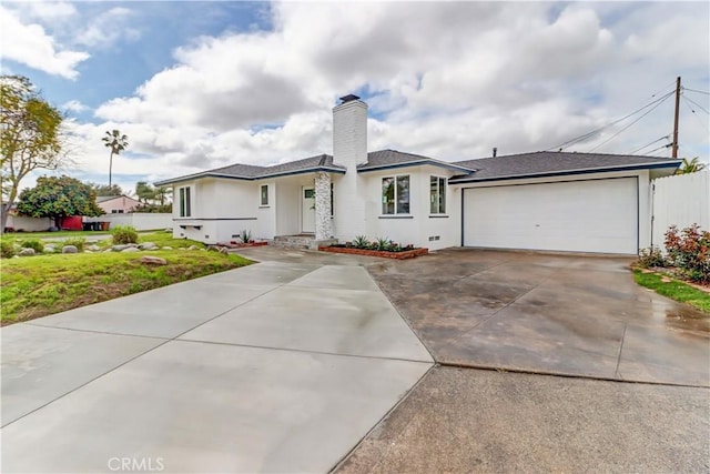 prairie-style home with stucco siding, driveway, fence, an attached garage, and a chimney