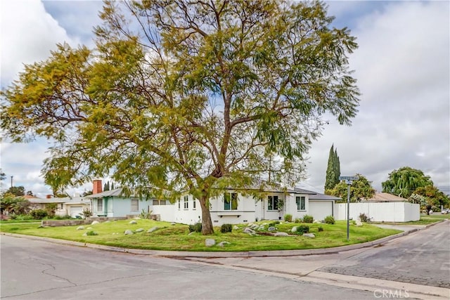 view of front of house with a front yard, an attached garage, and driveway