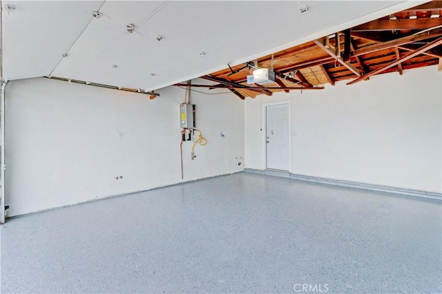 garage featuring a garage door opener and water heater