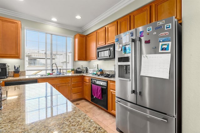 kitchen with light stone countertops, light tile patterned flooring, a sink, ornamental molding, and black appliances