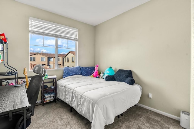 carpeted bedroom featuring baseboards