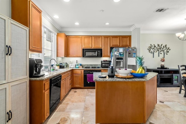 kitchen with light stone counters, a kitchen island, a sink, ornamental molding, and black appliances