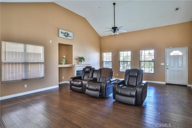 living room with baseboards, a ceiling fan, wood finished floors, and a fireplace