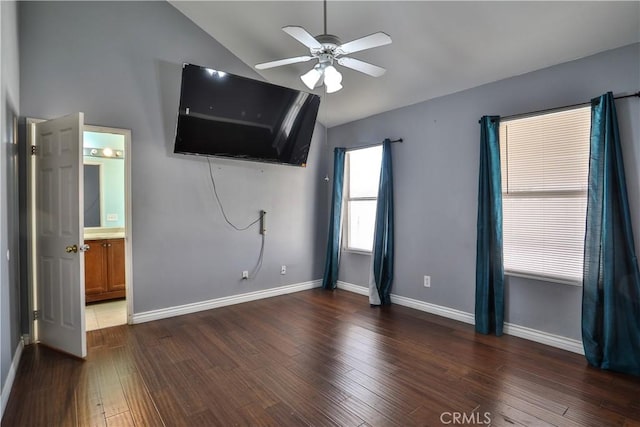 unfurnished living room featuring lofted ceiling, wood finished floors, baseboards, and ceiling fan