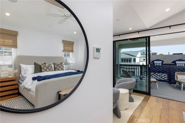 bedroom featuring access to outside, multiple windows, wood finished floors, and recessed lighting