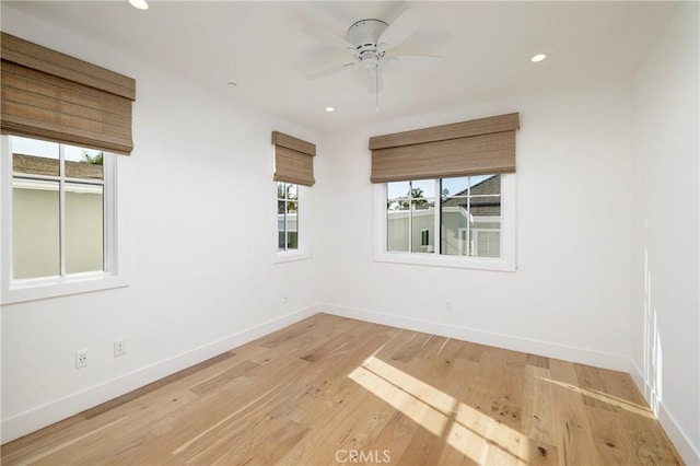 empty room with wood finished floors, baseboards, and a wealth of natural light