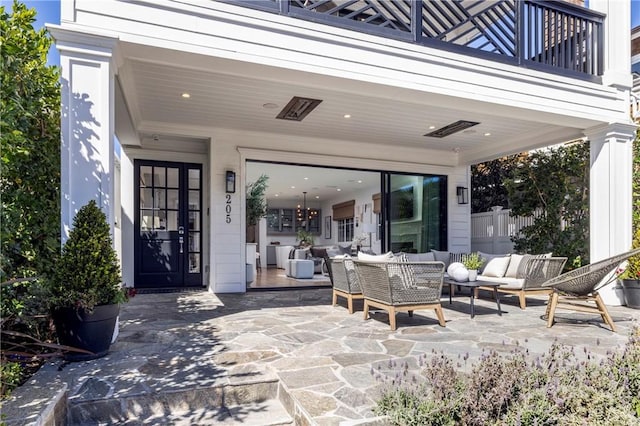 view of patio with a balcony and an outdoor hangout area