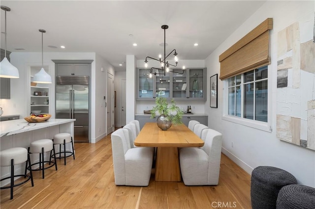 dining area featuring recessed lighting, baseboards, and light wood finished floors