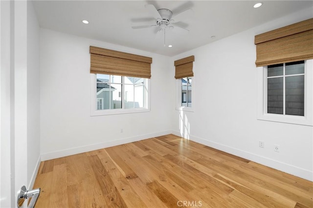 empty room featuring light wood finished floors, recessed lighting, a ceiling fan, and baseboards