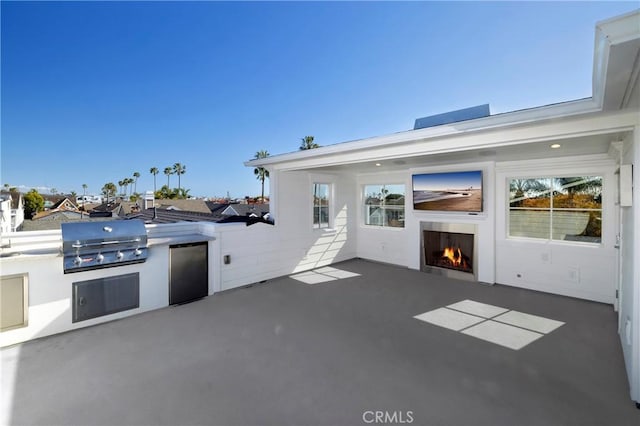 view of patio with area for grilling and an outdoor kitchen