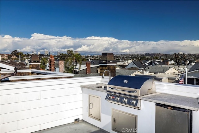 view of patio featuring a sink, a city view, and area for grilling