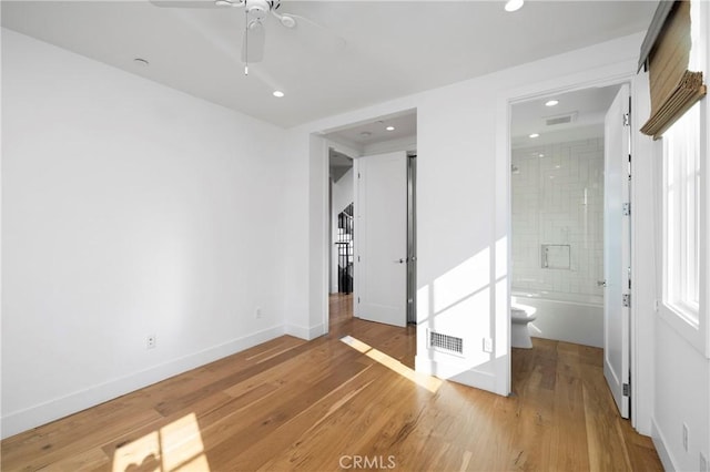 unfurnished bedroom with baseboards, visible vents, light wood finished floors, ensuite bath, and recessed lighting