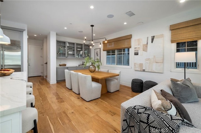 kitchen with light wood-style flooring, visible vents, gray cabinets, and stainless steel built in fridge