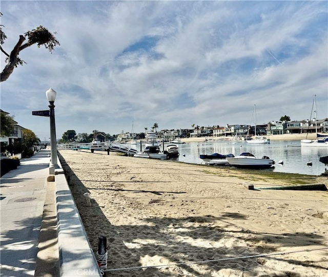 exterior space featuring a dock and a water view