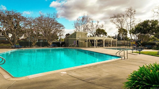 pool with a patio and fence