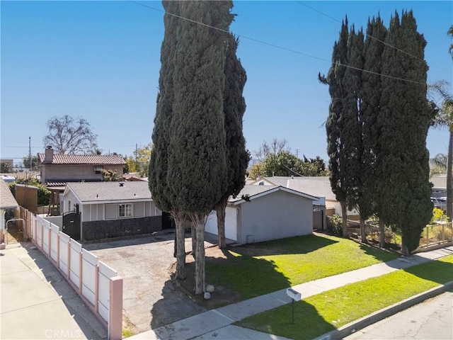 view of front of house with driveway, a front yard, and fence