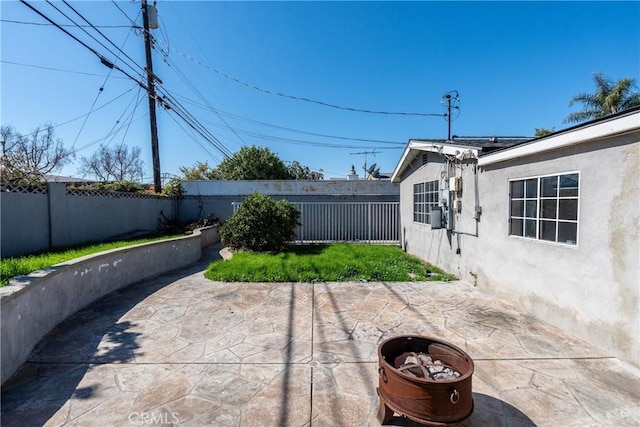 view of patio with a fire pit and a fenced backyard