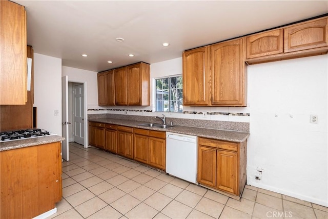 kitchen with brown cabinets, a sink, recessed lighting, stainless steel gas stovetop, and white dishwasher