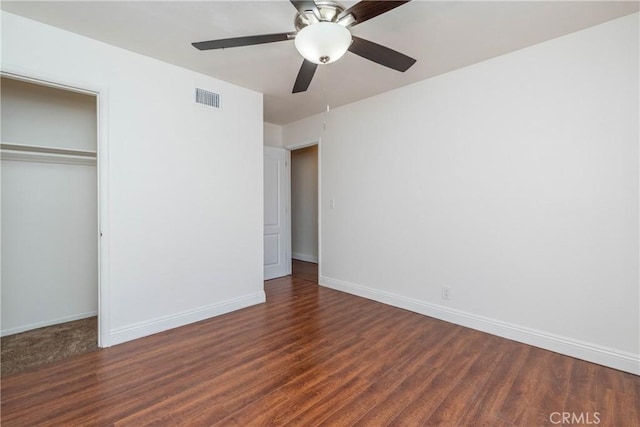 unfurnished bedroom with visible vents, ceiling fan, baseboards, wood finished floors, and a closet