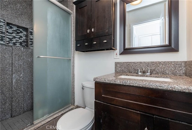 full bathroom featuring vanity, toilet, and a stall shower