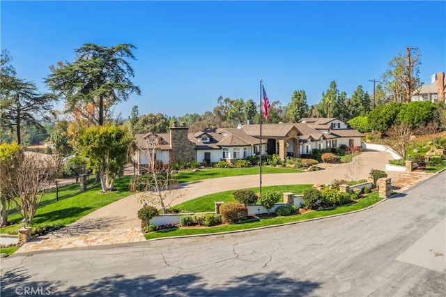 view of front of property with driveway and a front lawn