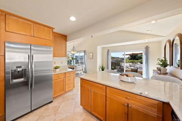 kitchen with light stone countertops, stainless steel fridge with ice dispenser, light tile patterned floors, recessed lighting, and brown cabinets