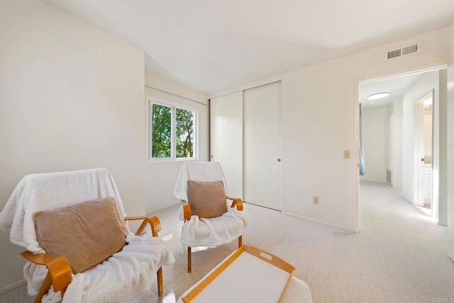 sitting room with visible vents and carpet floors