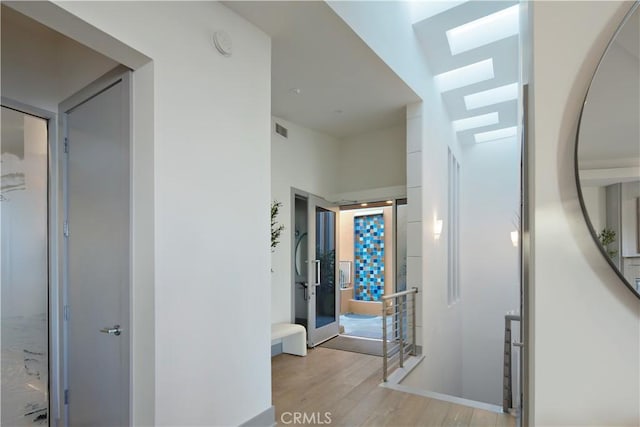 1415 Coral Dr, Laguna Beach, CA 92651 - corridor featuring light wood finished floors, visible vents, and a skylight