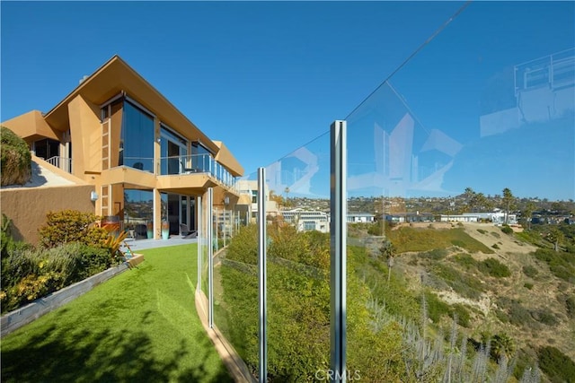 view of yard with a balcony