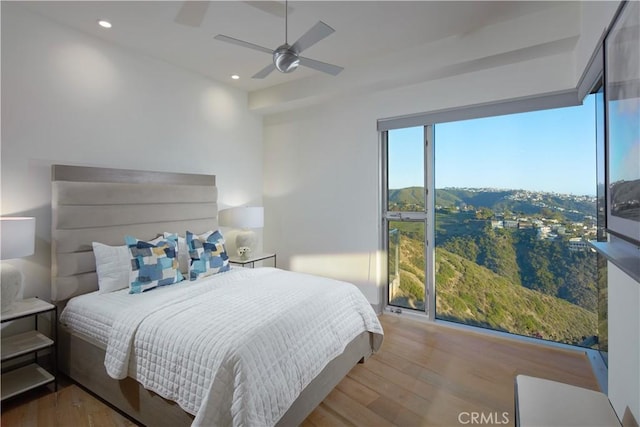 bedroom featuring recessed lighting, a ceiling fan, and wood finished floors