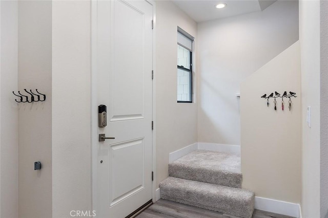 staircase featuring recessed lighting, baseboards, and wood finished floors