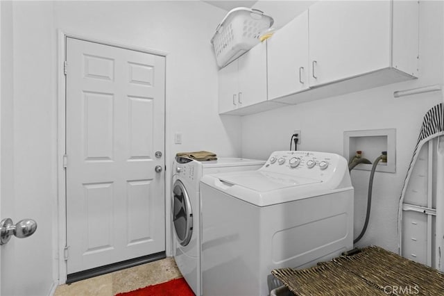 washroom featuring washer and clothes dryer and cabinet space