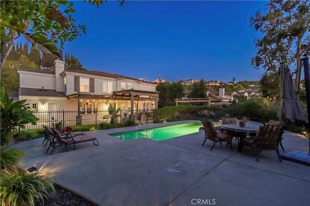 view of swimming pool with a fenced in pool, a patio area, fence, and outdoor dining space