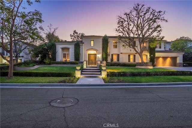 mediterranean / spanish home with a garage and driveway