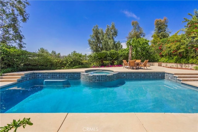 view of swimming pool with a pool with connected hot tub