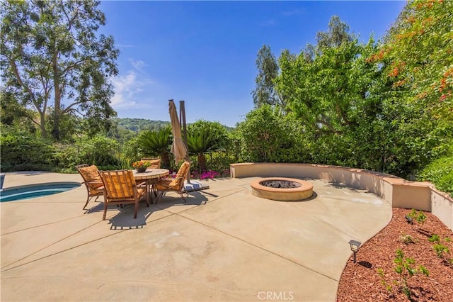 view of patio / terrace featuring outdoor dining area and an outdoor fire pit