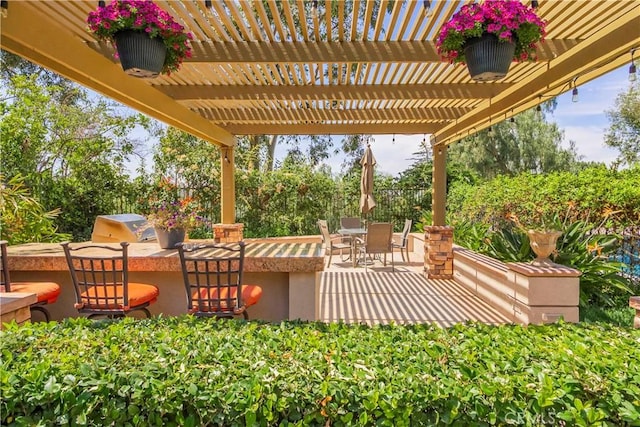view of patio / terrace with outdoor dining space, a grill, area for grilling, and a pergola
