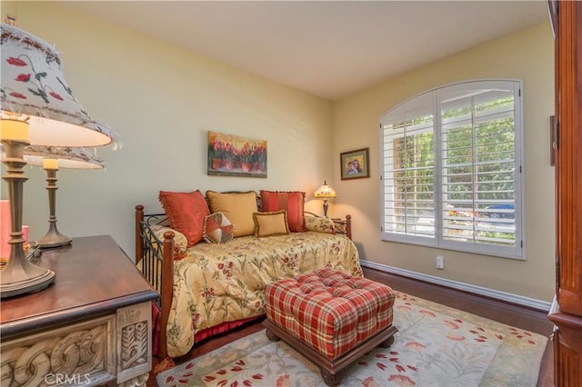 bedroom featuring baseboards and wood finished floors