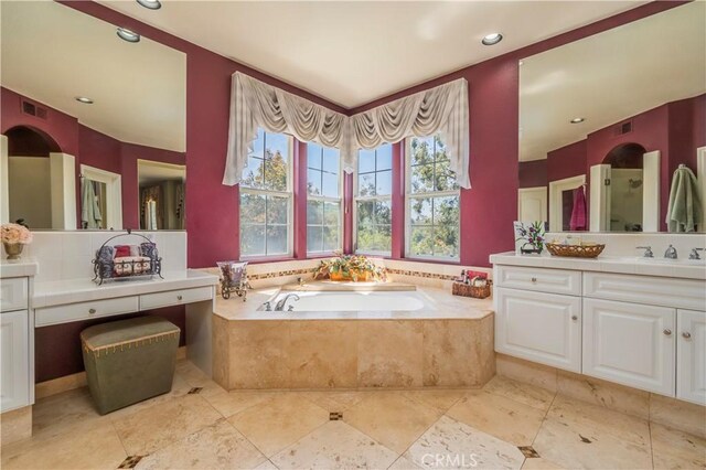 bathroom featuring a garden tub, vanity, visible vents, and recessed lighting
