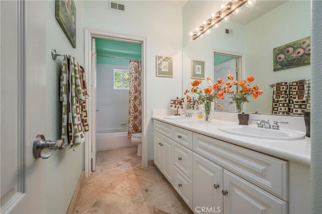 full bathroom with a sink, visible vents, toilet, and double vanity