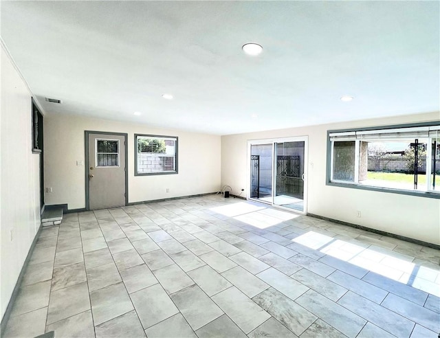 spare room with recessed lighting, visible vents, a healthy amount of sunlight, and light tile patterned floors